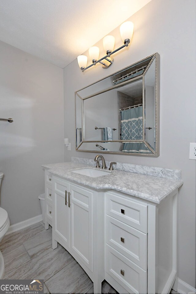 4814 Chesil Ave, Columbus, GA 31904 - full bath with toilet, vanity, and baseboards
