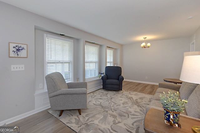 4814 Chesil Ave, Columbus, GA 31904 - living room with wood finished floors, a chandelier, and baseboards
