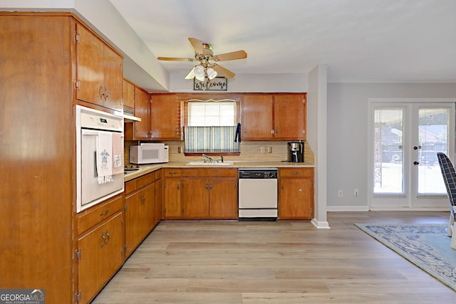 4814 Chesil Ave, Columbus, GA 31904 - kitchen with white appliances, a sink, ceiling fan, backsplash, and brown cabinets