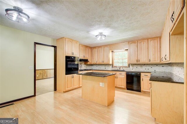 2612 Spring St, Dacula, GA 30019 - kitchen featuring black appliances, light brown cabinets, light wood finished floors, and a textured ceiling
