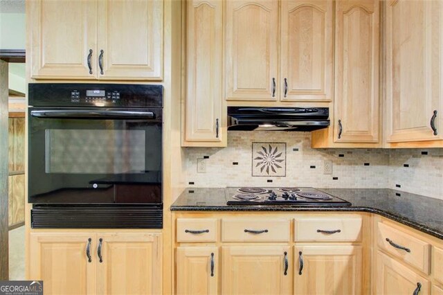 2612 Spring St, Dacula, GA 30019 - kitchen featuring black appliances, under cabinet range hood, light brown cabinetry, dark stone counters, and backsplash