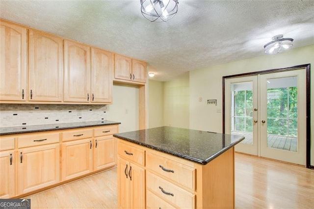 2612 Spring St, Dacula, GA 30019 - kitchen featuring light brown cabinetry, light wood-style flooring, a textured ceiling, tasteful backsplash, and french doors
