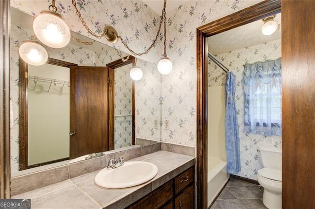 2612 Spring St, Dacula, GA 30019 - full bath featuring wallpapered walls, vanity, tile patterned floors, toilet, and shower / tub combo