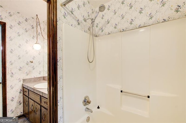 2612 Spring St, Dacula, GA 30019 - bathroom with wallpapered walls, bathing tub / shower combination, and vanity