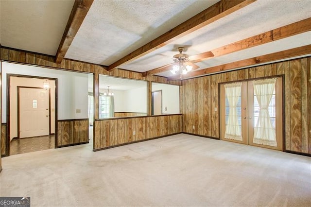 2612 Spring St, Dacula, GA 30019 - empty room featuring wooden walls, beamed ceiling, carpet, french doors, and baseboards