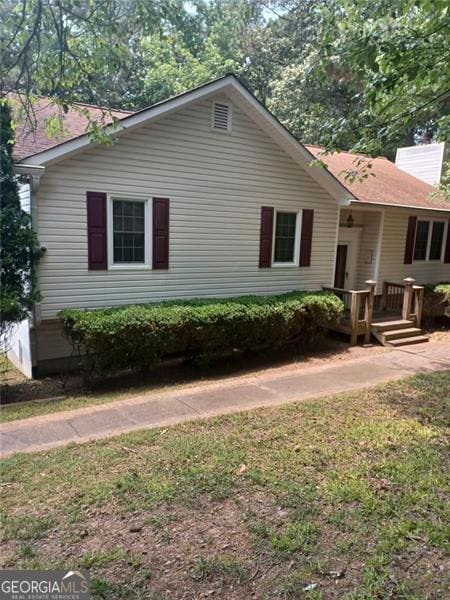 291 Briar Rdg, Woodstock, GA 30189 - view of side of home featuring a chimney, a wooden deck, and a lawn