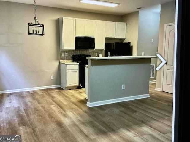 5057 Windsor Forrest Ln, Atlanta, GA 30349 - kitchen featuring black appliances, wood finished floors, and white cabinets