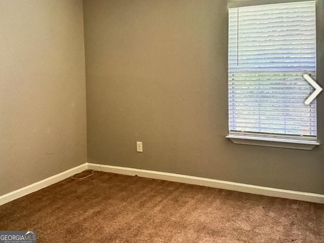 5057 Windsor Forrest Ln, Atlanta, GA 30349 - spare room featuring carpet and baseboards