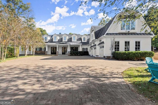 13535 Blakmaral Ln, Milton, GA 30004 - view of front of home with decorative driveway, a standing seam roof, and a metal roof