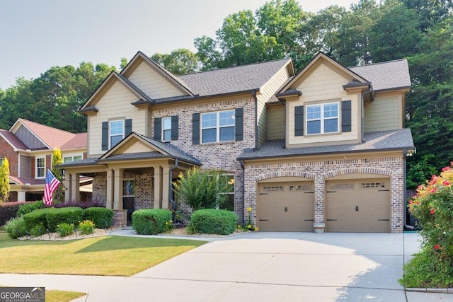 2525 Well Springs Dr, Buford, GA 30519 - craftsman house featuring brick siding, driveway, an attached garage, a front lawn, and roof with shingles