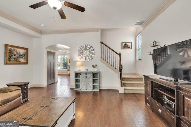 2525 Well Springs Dr, Buford, GA 30519 - living room featuring arched walkways, stairway, ceiling fan, dark wood finished floors, and ornamental molding