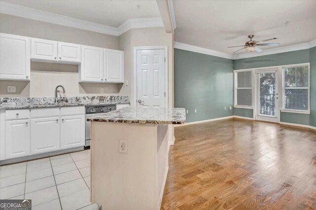 1850 Cotillion Dr Unit 3305, Dunwoody, GA 30338 - kitchen with dishwashing machine, a sink, a ceiling fan, light stone countertops, and white cabinets