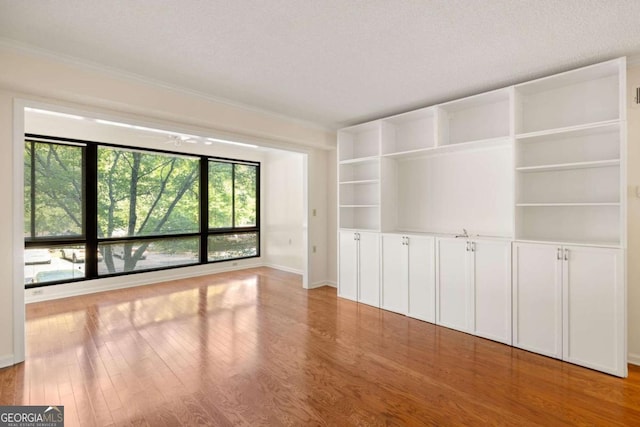 1800 Clairmont Lk Unit 216, Decatur, GA 30033 - spare room with plenty of natural light, wood finished floors, and ornamental molding