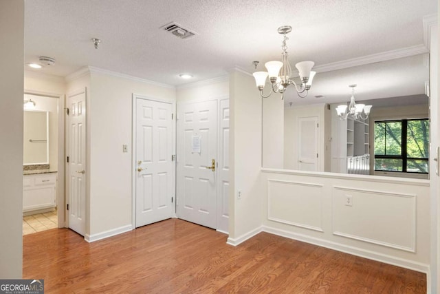 1800 Clairmont Lk Unit 216, Decatur, GA 30033 - unfurnished dining area with a chandelier, wood finished floors, ornamental molding, a textured ceiling, and recessed lighting