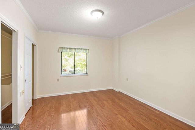 1800 Clairmont Lk Unit 216, Decatur, GA 30033 - unfurnished bedroom with wood finished floors, ornamental molding, and a textured ceiling