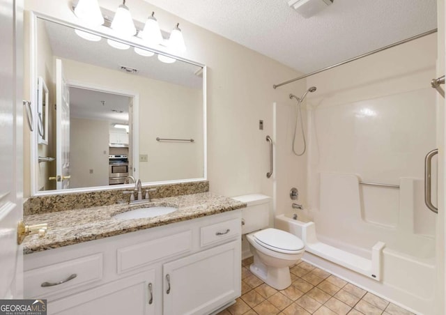1800 Clairmont Lk Unit 216, Decatur, GA 30033 - full bathroom with tile patterned flooring, washtub / shower combination, vanity, and a textured ceiling