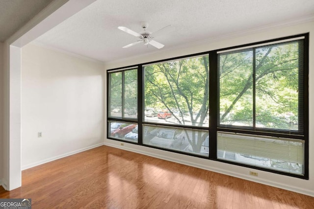 1800 Clairmont Lk Unit 216, Decatur, GA 30033 - empty room featuring a textured ceiling, ornamental molding, wood finished floors, and ceiling fan