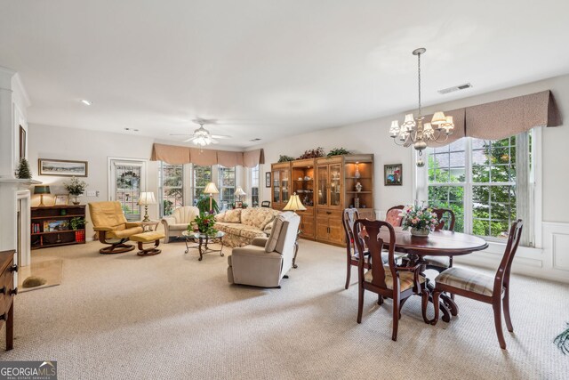 5105 Kings Common Way, Cumming, GA 30040 - dining room with light colored carpet, a chandelier, and a ceiling fan