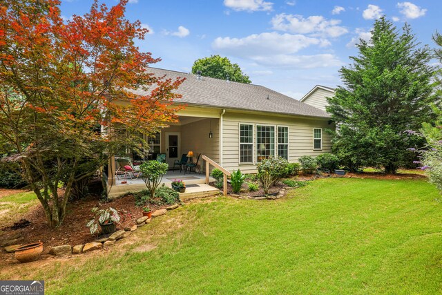 5105 Kings Common Way, Cumming, GA 30040 - back of property with a patio area, a yard, and roof with shingles