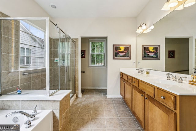 5105 Kings Common Way, Cumming, GA 30040 - bathroom with double vanity, a garden tub, a shower stall, baseboards, and tile patterned floors