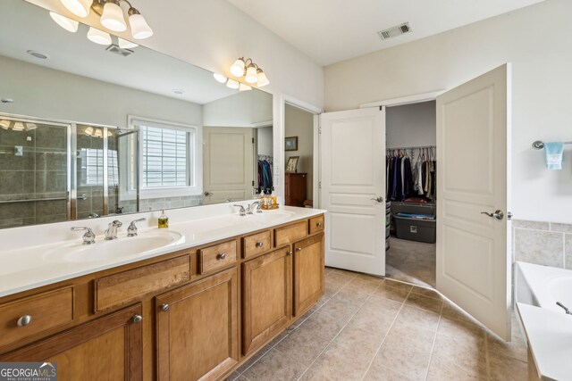 5105 Kings Common Way, Cumming, GA 30040 - full bath featuring a walk in closet, double vanity, a stall shower, a garden tub, and tile patterned floors