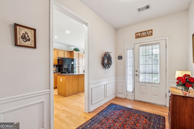 5105 Kings Common Way, Cumming, GA 30040 - entrance foyer with light wood-type flooring, a wainscoted wall, and a decorative wall