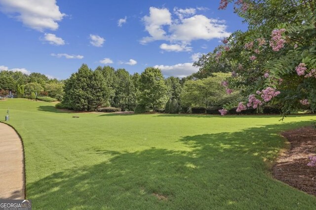 5105 Kings Common Way, Cumming, GA 30040 - view of community featuring a lawn and view of wooded area