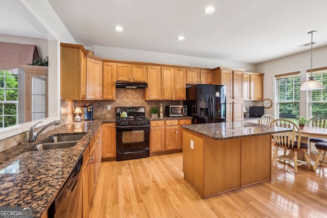 5105 Kings Common Way, Cumming, GA 30040 - kitchen with black appliances, under cabinet range hood, a sink, light wood-type flooring, and recessed lighting