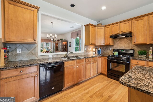 5105 Kings Common Way, Cumming, GA 30040 - kitchen with black appliances, a sink, under cabinet range hood, light wood-style flooring, and backsplash