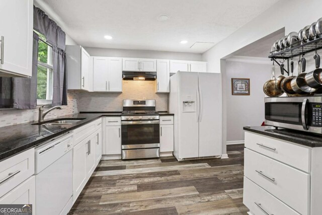 2860 Jefferson St, Austell, GA 30106 - kitchen with stainless steel appliances, under cabinet range hood, dark wood finished floors, white cabinetry, and recessed lighting