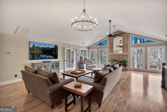 201 Hickory Hill Ln, Martin, GA 30557 - living area with baseboards, ceiling fan, a chandelier, light wood-style flooring, and a textured ceiling