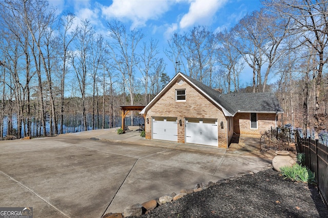 201 Hickory Hill Ln, Martin, GA 30557 - view of property exterior featuring brick siding, driveway, a garage, and a shingled roof