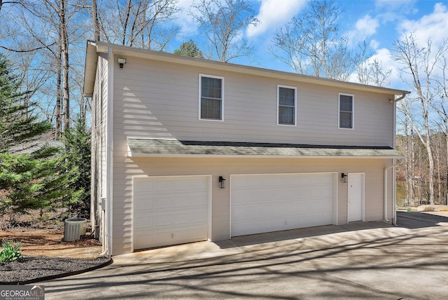 201 Hickory Hill Ln, Martin, GA 30557 - view of side of home with an attached garage, driveway, and central AC