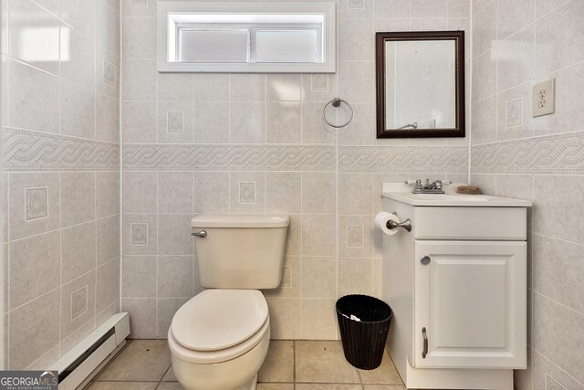 201 Hickory Hill Ln, Martin, GA 30557 - bathroom featuring tile walls, a baseboard heating unit, toilet, vanity, and tile patterned floors