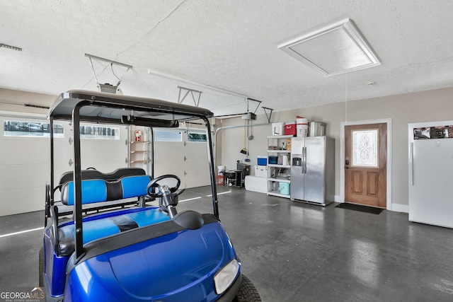 201 Hickory Hill Ln, Martin, GA 30557 - garage featuring stainless steel refrigerator with ice dispenser, a garage door opener, and freestanding refrigerator