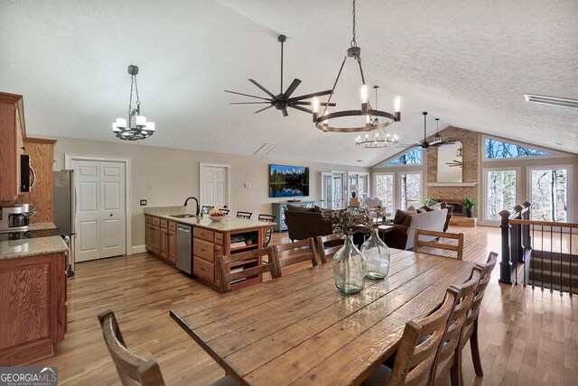 201 Hickory Hill Ln, Martin, GA 30557 - dining area featuring a chandelier, lofted ceiling, light wood-style flooring, and a ceiling fan