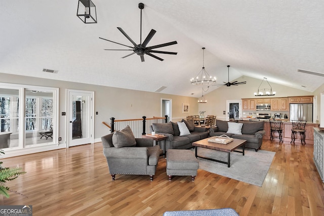 201 Hickory Hill Ln, Martin, GA 30557 - living room with a chandelier, light wood finished floors, ceiling fan, and high vaulted ceiling
