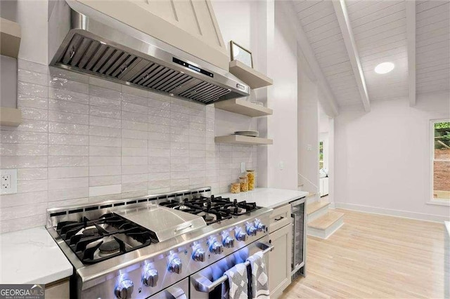6405 Cherry Tree Ln, Atlanta, GA 30328 - kitchen featuring wall chimney exhaust hood, stainless steel range, decorative backsplash, open shelves, and wine cooler