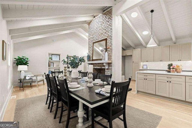 6405 Cherry Tree Ln, Atlanta, GA 30328 - dining space with light wood-type flooring and a brick fireplace