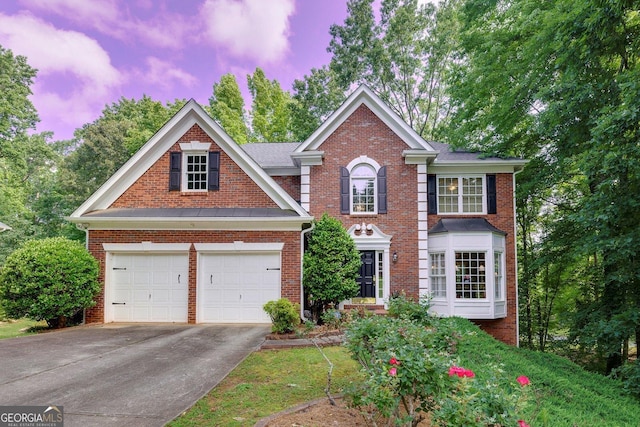 6302 Manassas Pass NW, Acworth, GA 30101 - view of front of house featuring driveway, brick siding, and an attached garage
