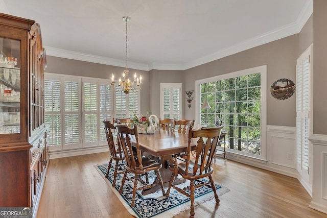 6302 Manassas Pass NW, Acworth, GA 30101 - dining room with a chandelier, light wood-style floors, wainscoting, and ornamental molding