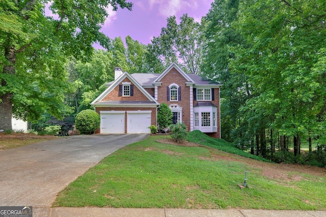 6302 Manassas Pass NW, Acworth, GA 30101 - view of front facade with brick siding, a chimney, concrete driveway, a lawn, and a garage