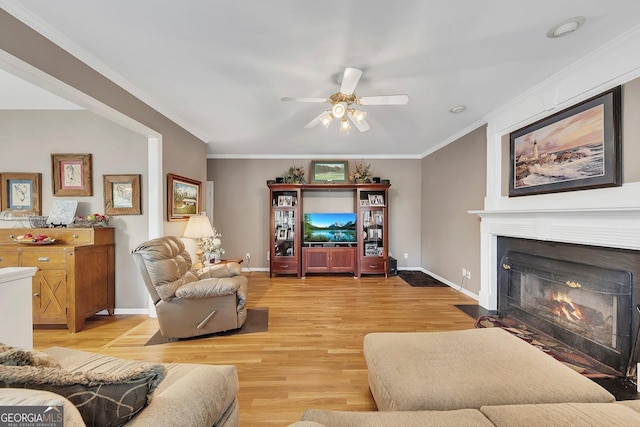 6302 Manassas Pass NW, Acworth, GA 30101 - living room with light wood-style flooring, ceiling fan, a fireplace with flush hearth, and ornamental molding