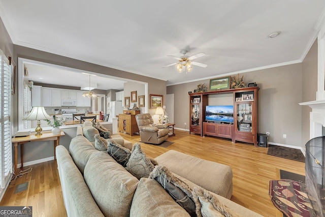 6302 Manassas Pass NW, Acworth, GA 30101 - living area with ceiling fan, light wood-style flooring, a fireplace, and crown molding