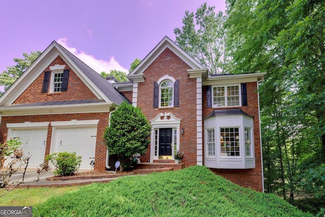 6302 Manassas Pass NW, Acworth, GA 30101 - colonial-style house with brick siding, a garage, and driveway