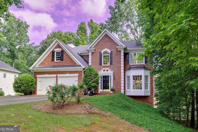 6302 Manassas Pass NW, Acworth, GA 30101 - view of front of property featuring brick siding, driveway, a garage, and a chimney