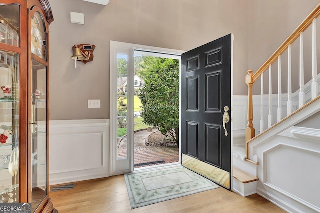 6302 Manassas Pass NW, Acworth, GA 30101 - foyer entrance with wood finished floors, stairs, a wainscoted wall, and a decorative wall