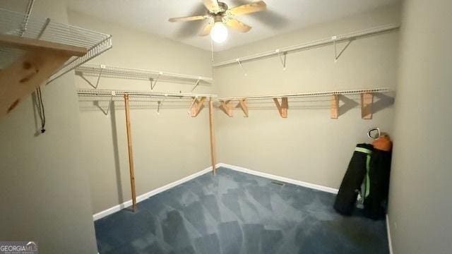279 Baker Cir SE, Calhoun, GA 30701 - walk in closet with dark carpet and a ceiling fan