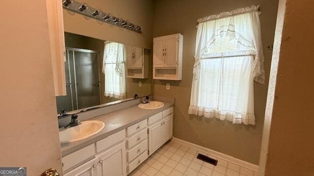 279 Baker Cir SE, Calhoun, GA 30701 - full bathroom with a shower stall, double vanity, tile patterned flooring, and baseboards