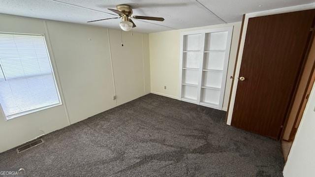 279 Baker Cir SE, Calhoun, GA 30701 - empty room with ceiling fan and dark colored carpet